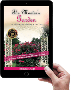 Hand holding ebook of The Master's Garden with Devotional