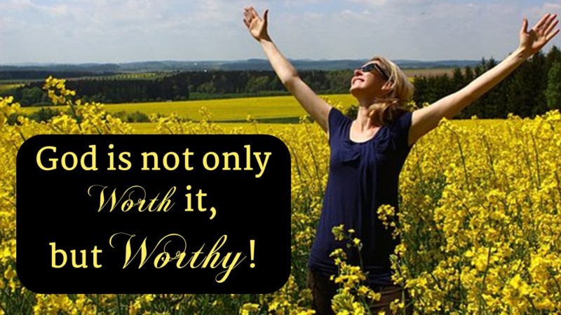 lady in yellow flower field with upright arms praising God