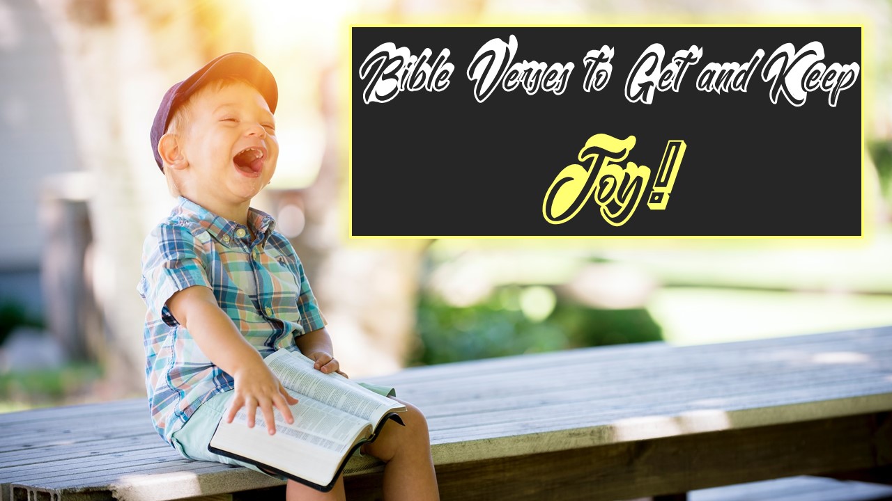 laughing young boy with open bible on lap