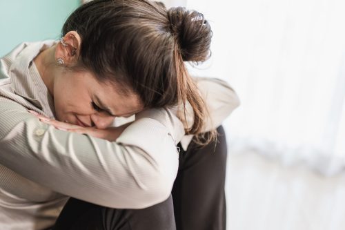 emotional woman crying with head down