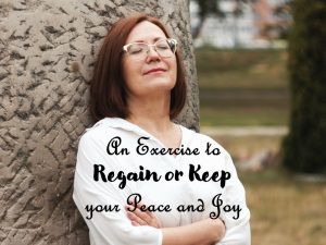 woman leaning against tree with complete peace on her face