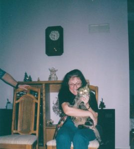 woman holding cat in living room
