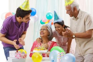 family singing happy birthday to mother