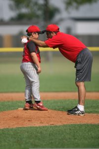 baseball coach encouraging downcast boy