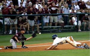 baseball player lunging to reach home plate