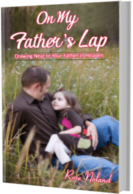 Adoring young girl sitting on her father's lap in a field